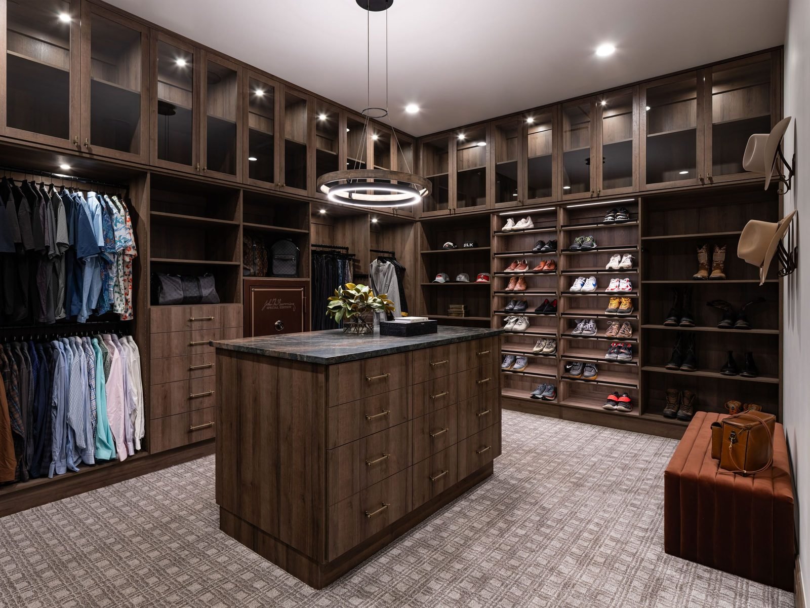Men's walk-in closet with island and built-in safe