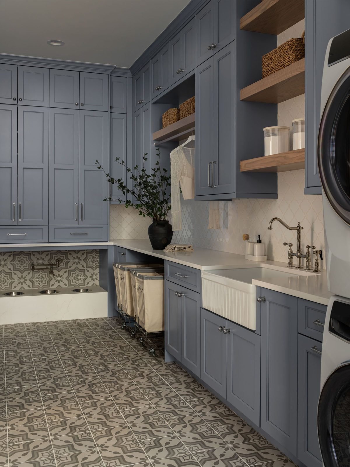 Laundry room with slate-blue cabinetry and pet feeding station