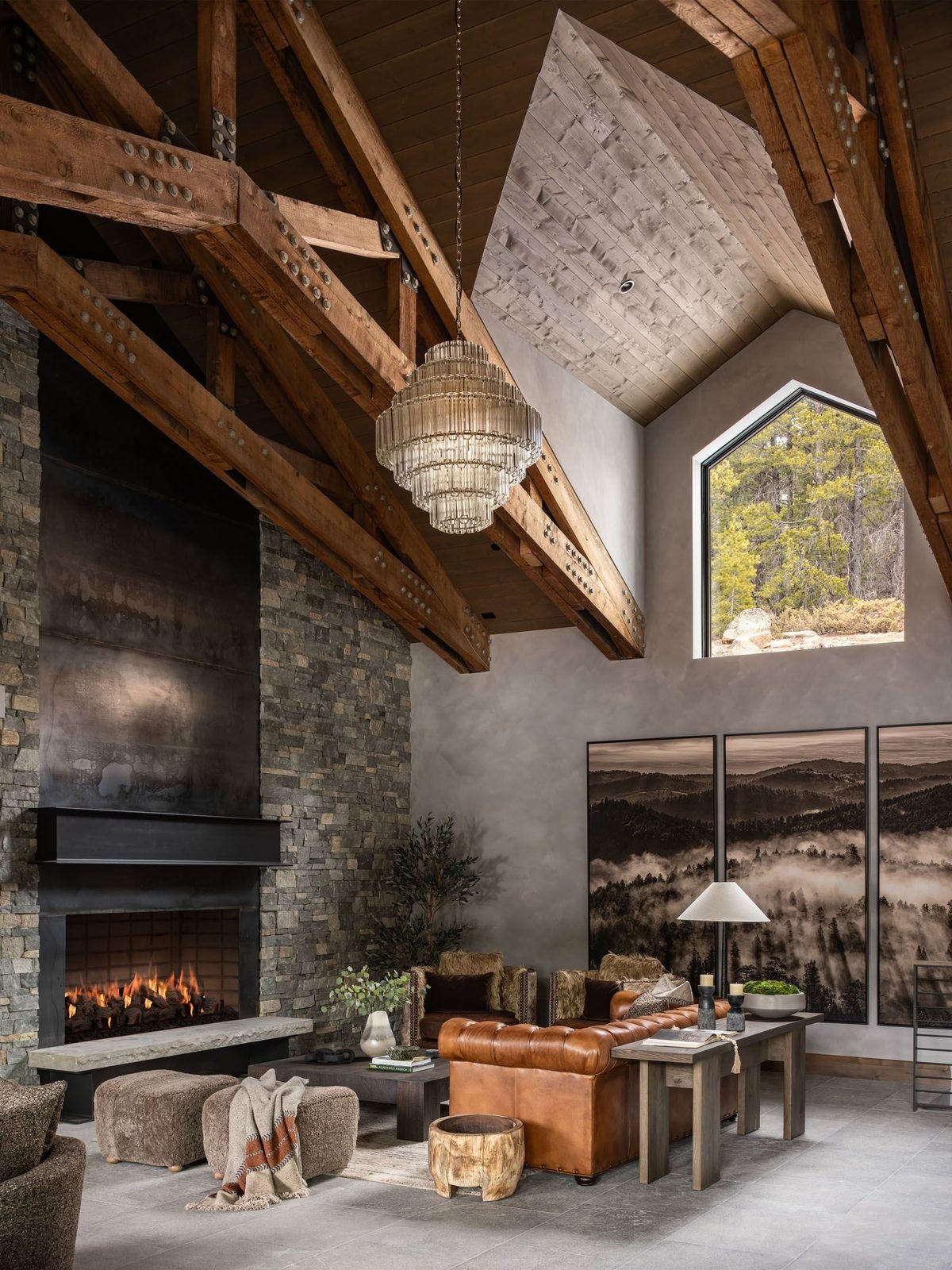 Fireside lounge with leather chesterfield and mountain photography